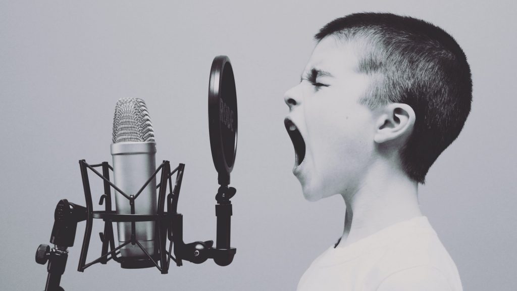 Someone screaming into a microphone through a pop shield.