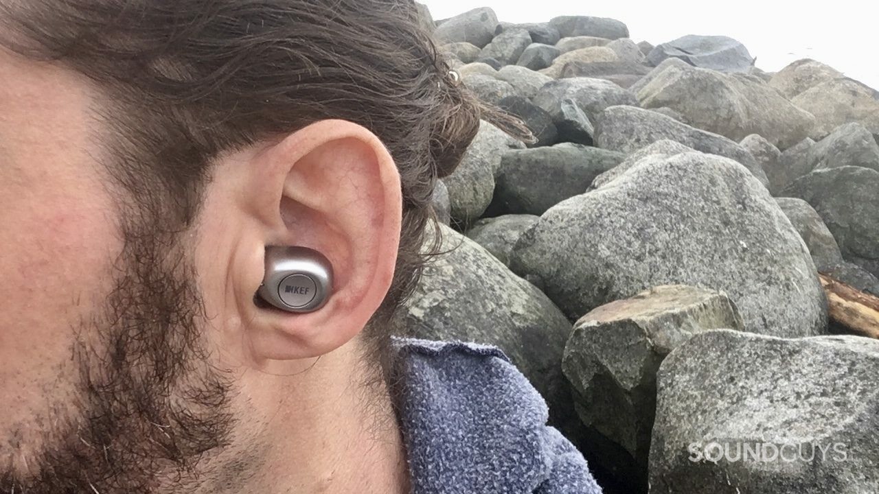The KEF mu3 shown in the ear in a profile shot of the reviewer's head.