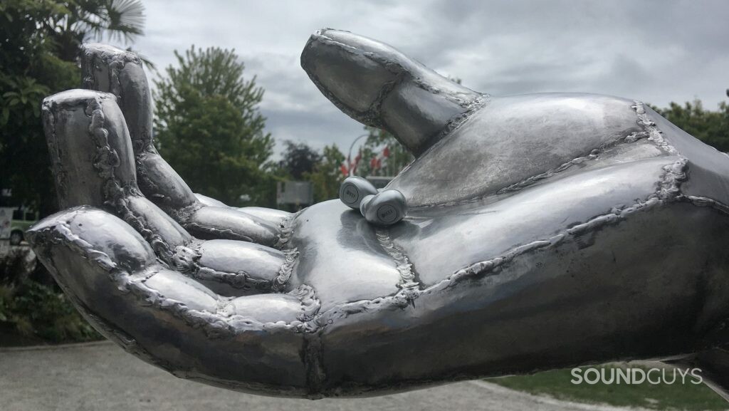 The KEF Mu3 shown sitting in a large silver statue's hand.