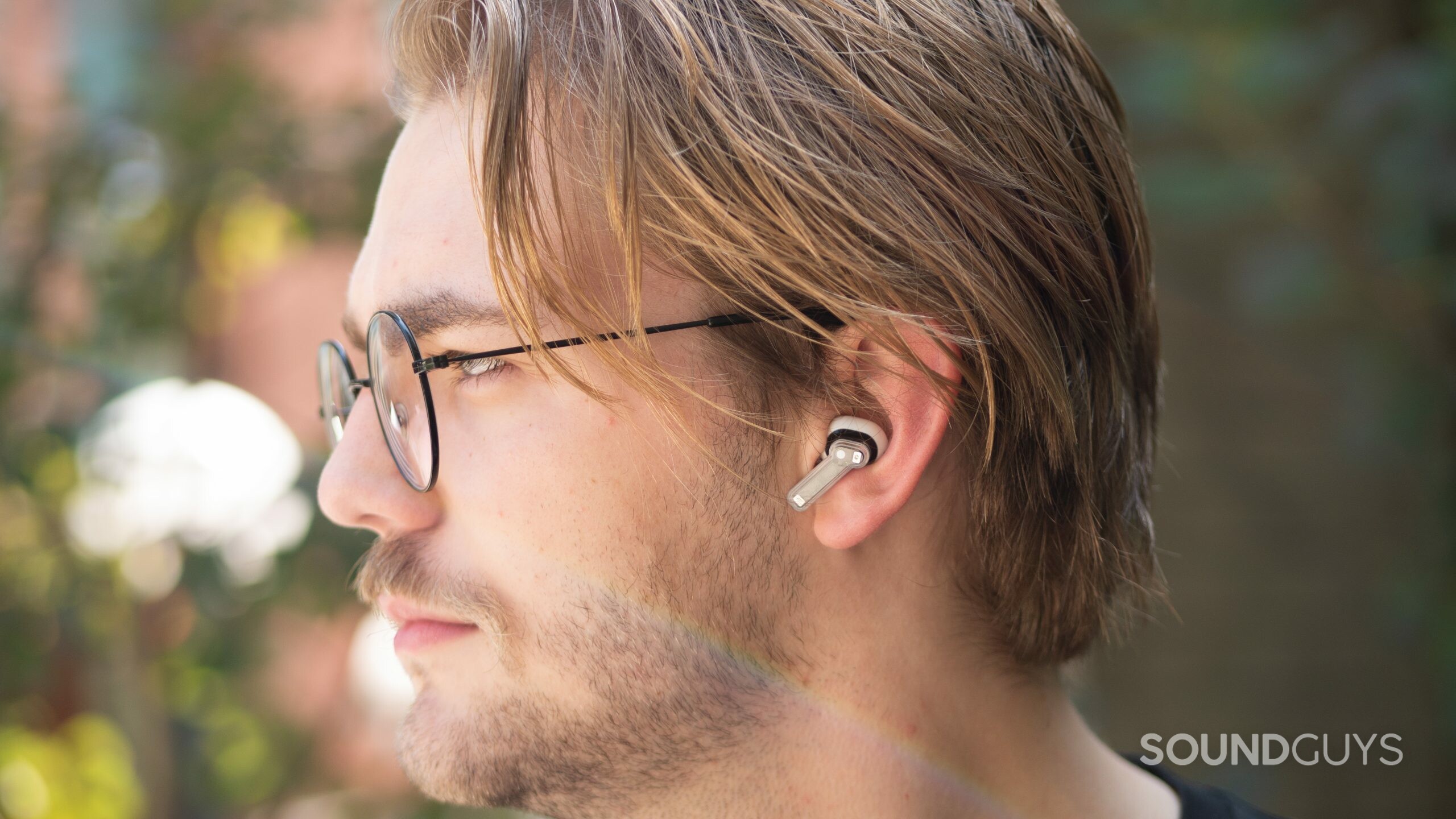 Side profile of Nothing Ear 1 earbuds being worn outside.