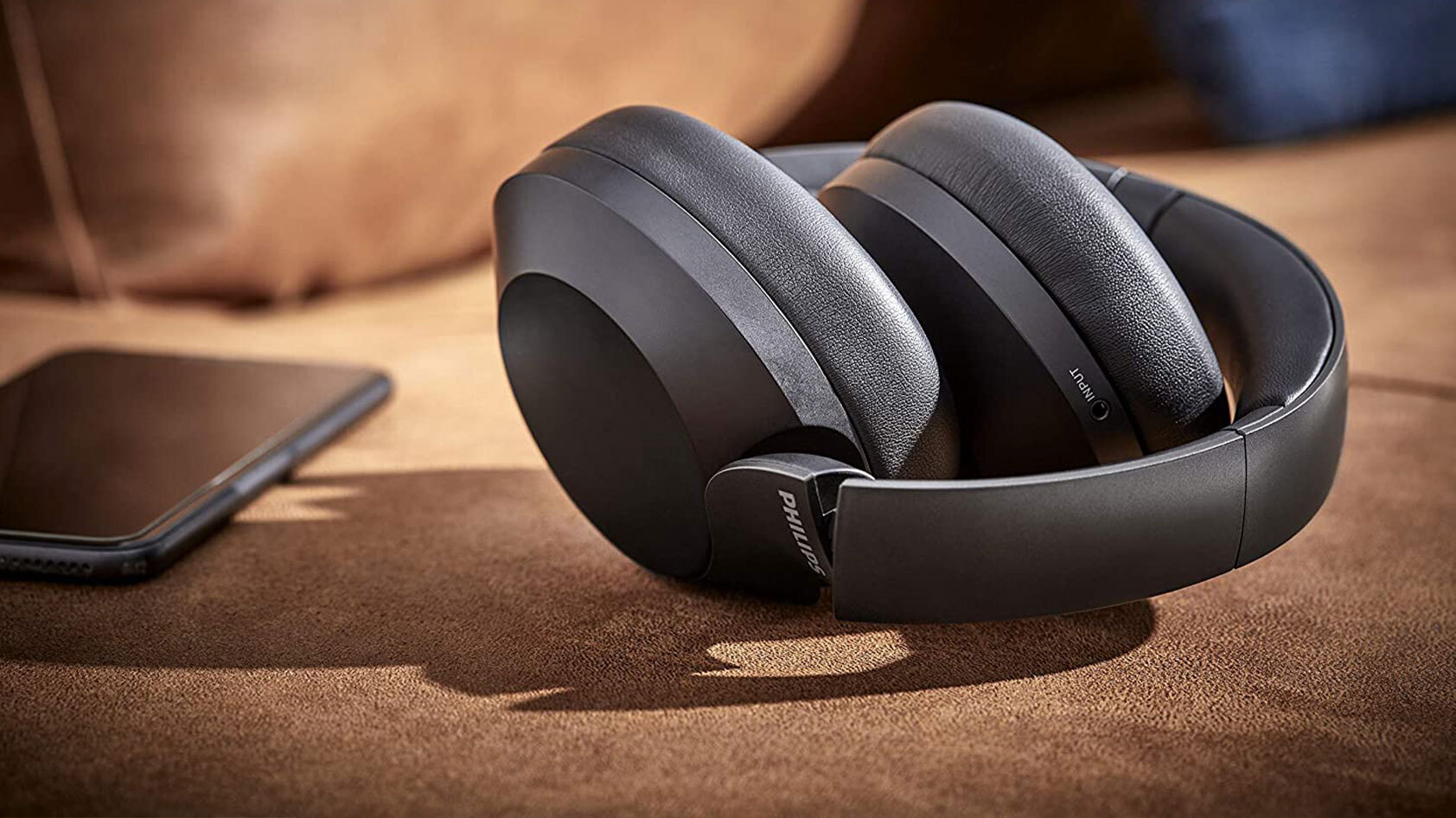Philips PH805 resting on a flat surface next to a smart phone.