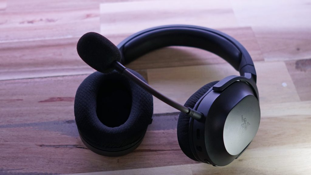 The Razer Barracuda X lays on a wooden table.