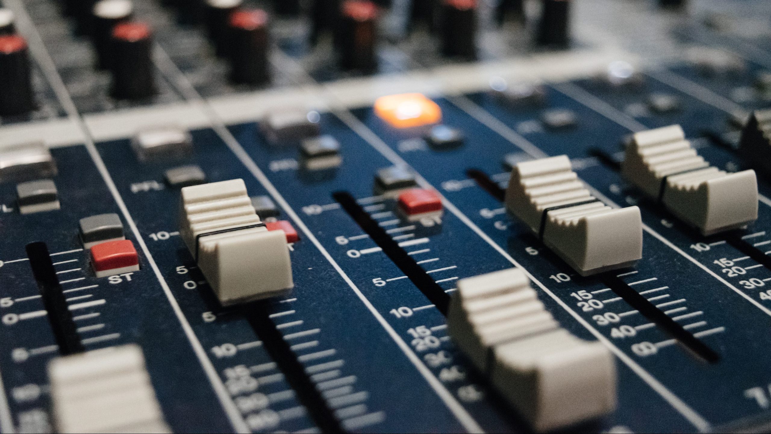 Close up of faders on a mixing console.