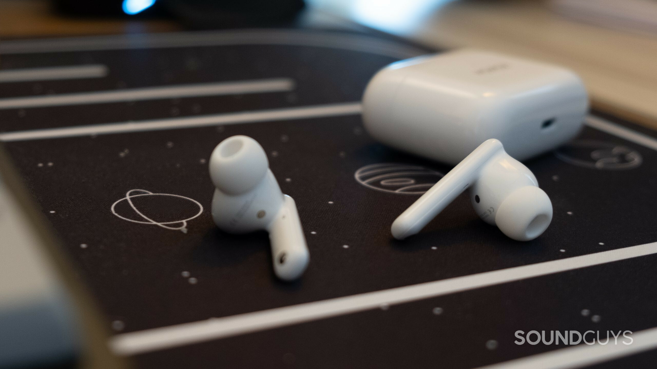 honor earbuds 2 lite rest on a space background covered desk