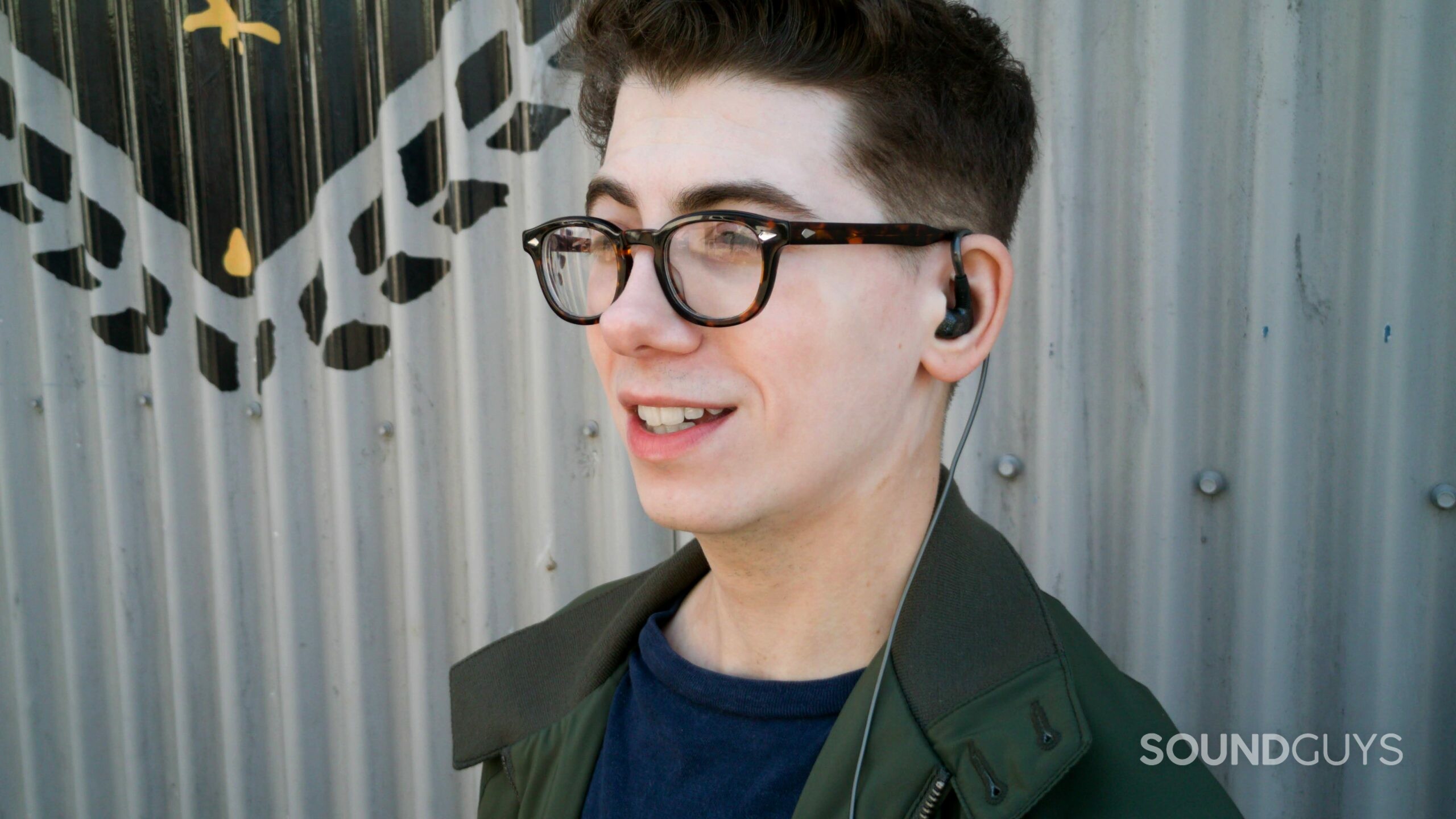 A man is wearing the sennheiser ie 300 earbuds.