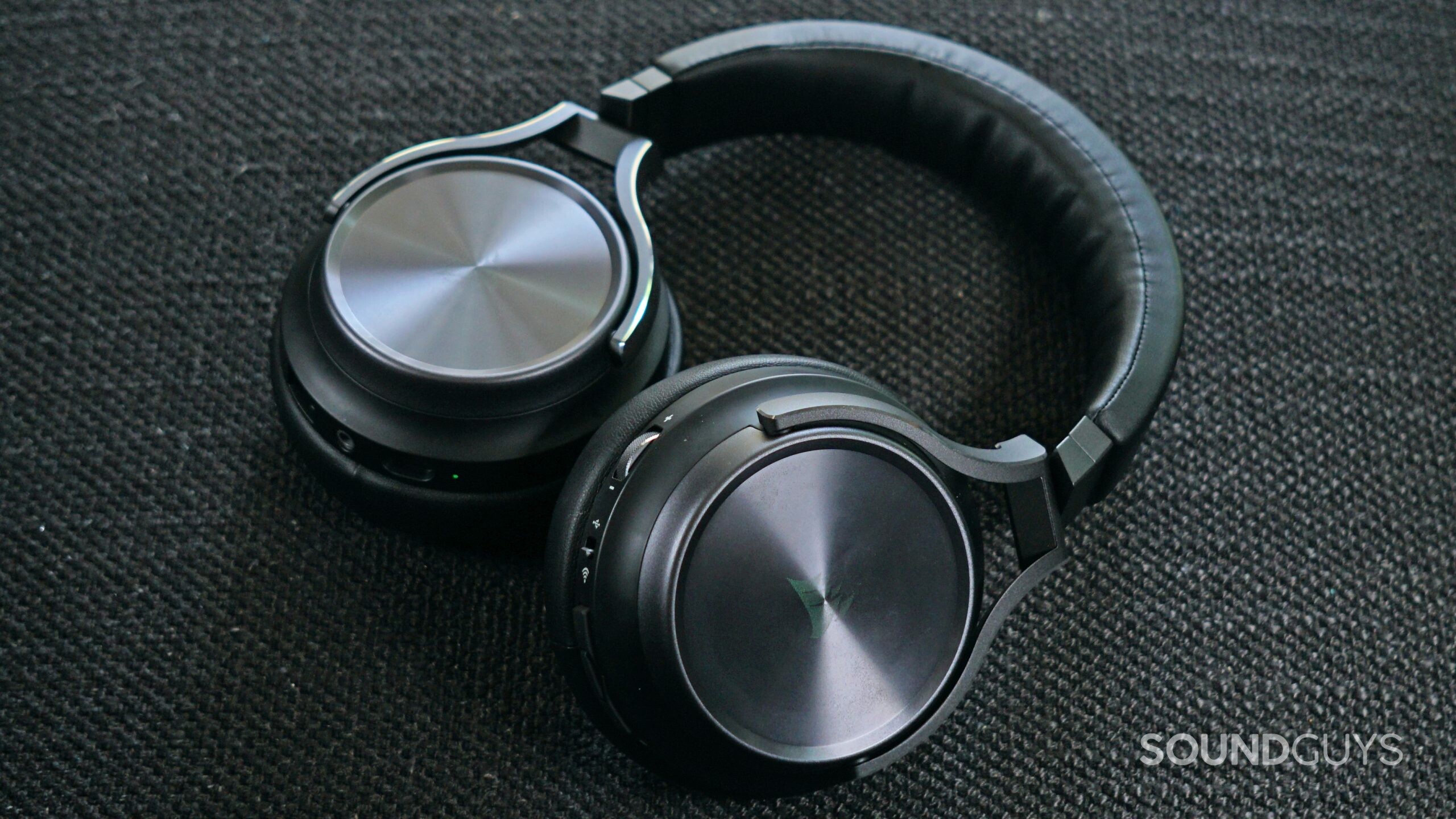 The Corsair Virtuoso RGB Wireless XT lays on a fabric surface with its mic detached.