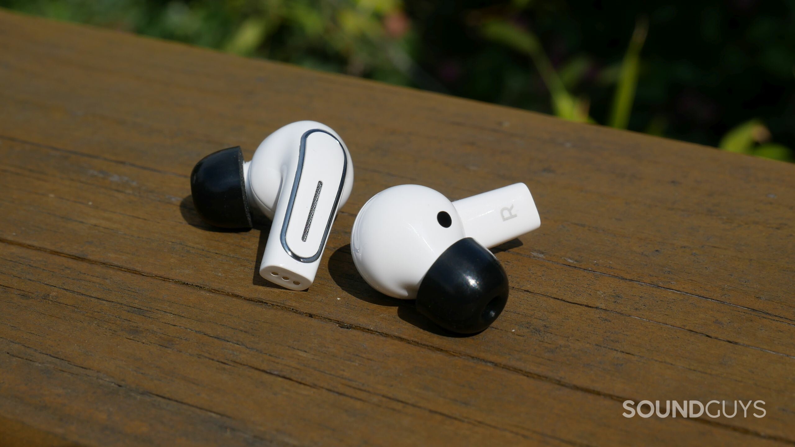 A pair of Olive Pro earbuds