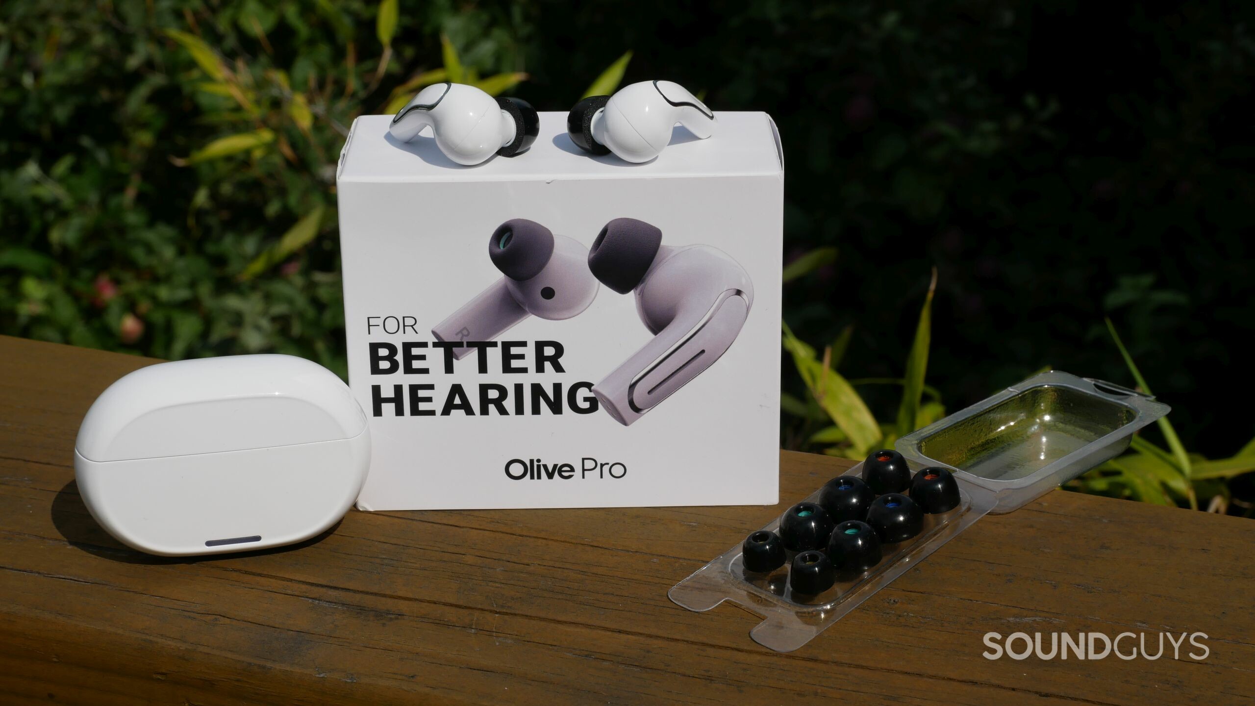 Olive Union Olive Pro earbuds with charging case and foam ear tips.