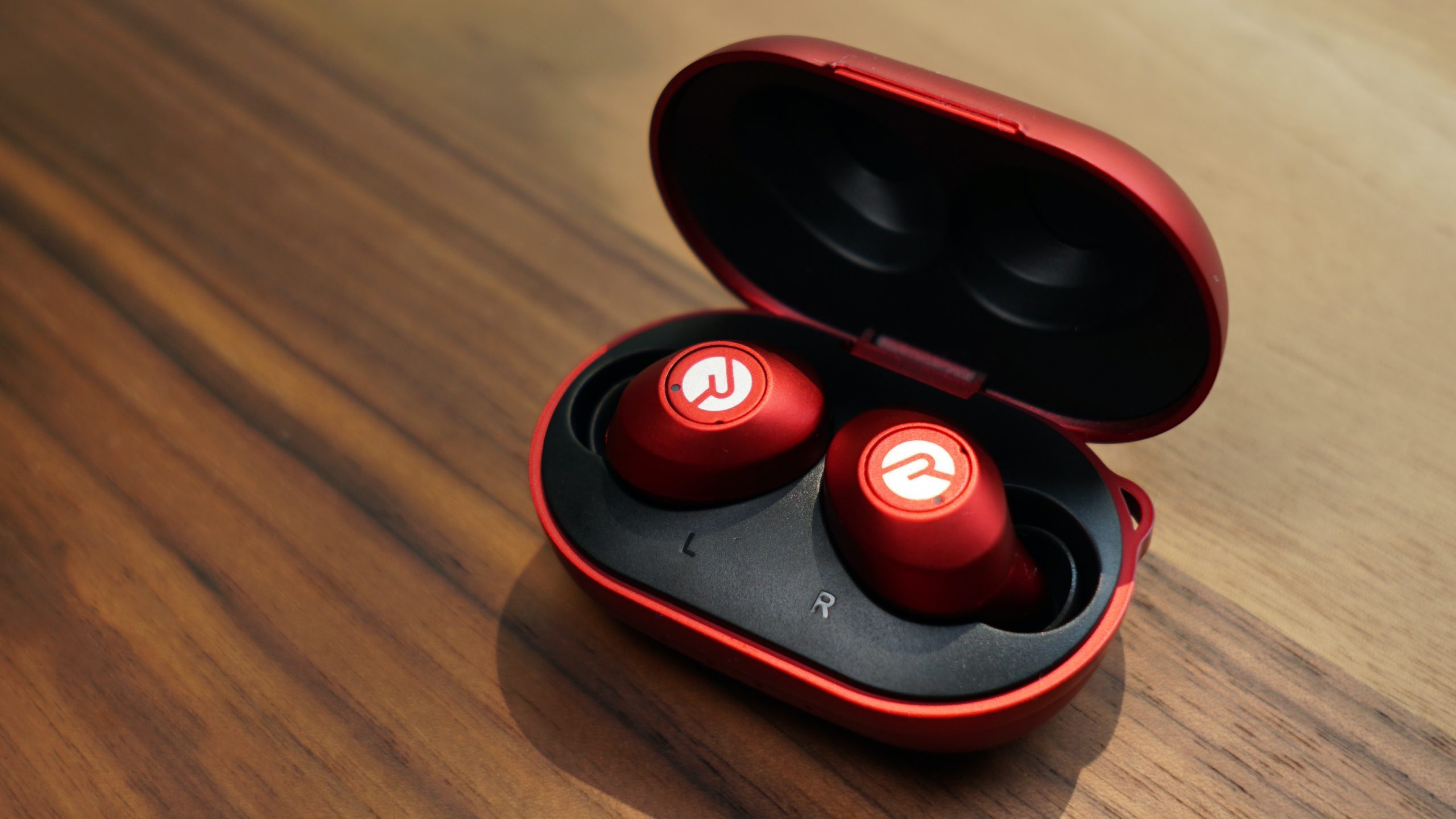 Image showing Raycon Everyday Earbuds with an open case, placed on a table