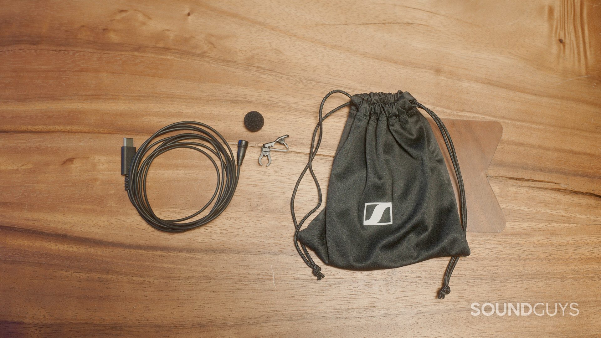 The Sennheiser XS Lav USB-C and its accessories: foam windscreen, microphone clip, and carrying pouch.