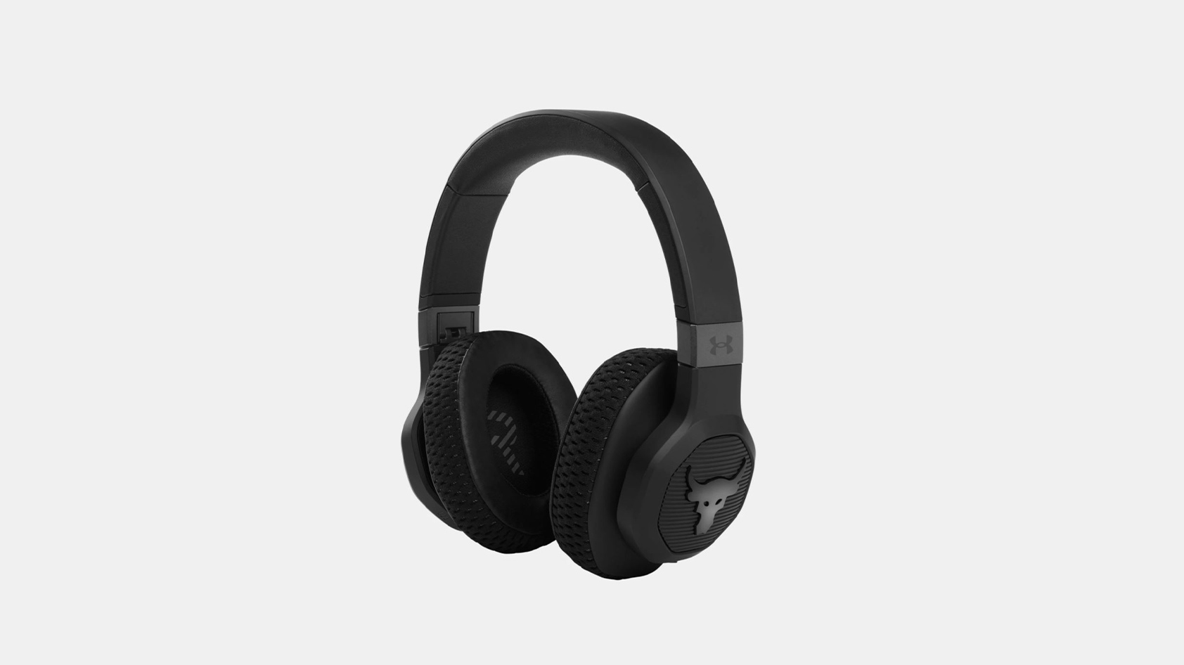 The UA Project Rock Over-Ear Training Headphones - Engineered by JBL in black against a grey background.