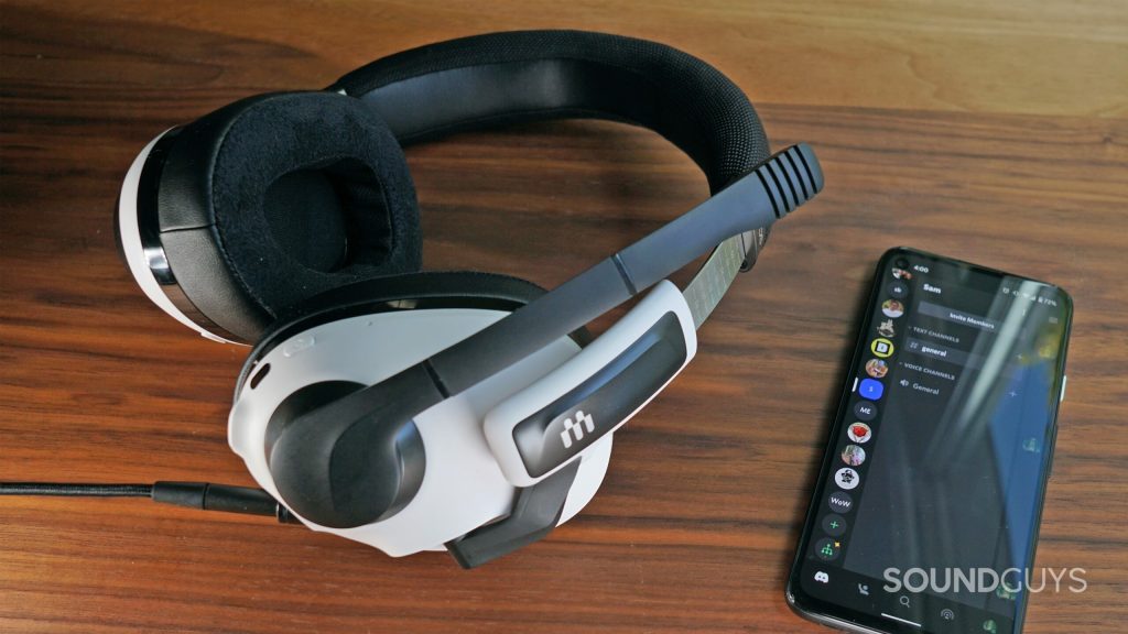 The EPOS H3 Hybrid lays on a wooden table next to a Google Pixel 4a with Discord open.