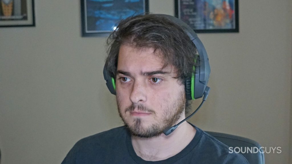 A man wears the HyperX CloudX Stinger Core sitting a t desk.