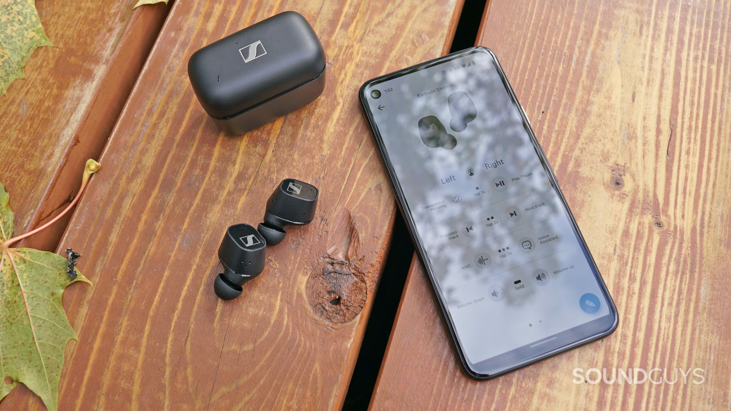 The Sennheiser CX Plus True Wireless earbuds lay on a wooden bench outside, paired to a Google Pixel 4a running the Sennheiser Smart Control app.