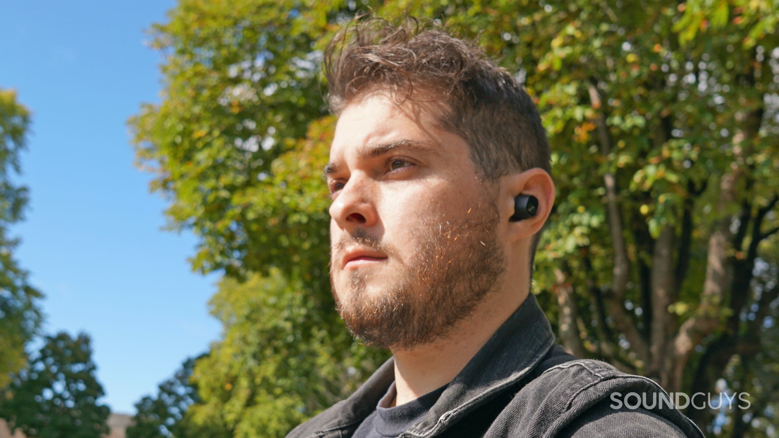 A man sits outside wearing the Sennheiser CX Plus True Wireless.