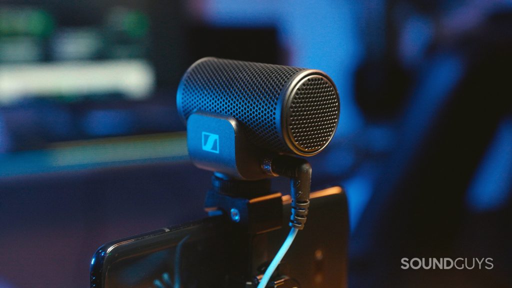 The Sennheiser MKE 200 shotgun microphone mounted onto a black smartphone.