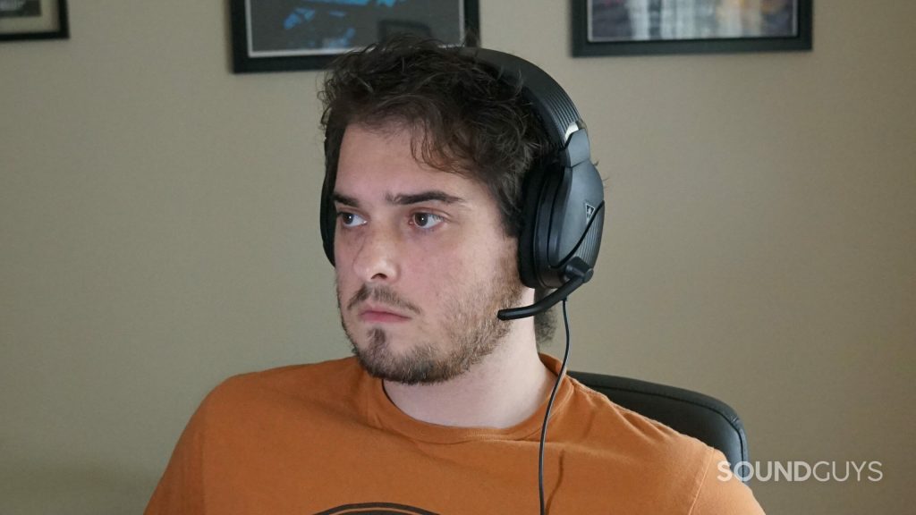 A man sits at a PC wearing the Turtle Beach Recon 200 Gen 2 gaming headset