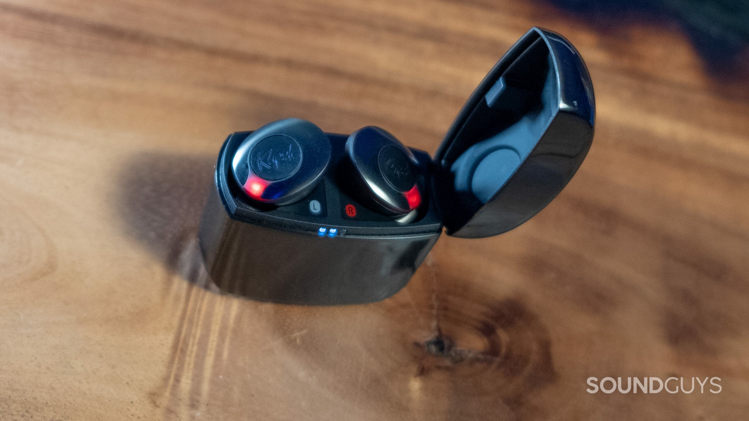 Open case seen from above with red lights on each bud illuminated and white case lights of the Klipsch T5 II ANC.