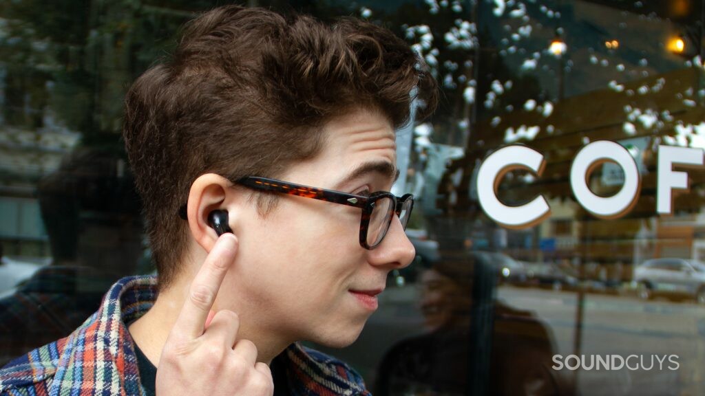 A close up profile of a man using touch controls on the LG TONE Free FP8.