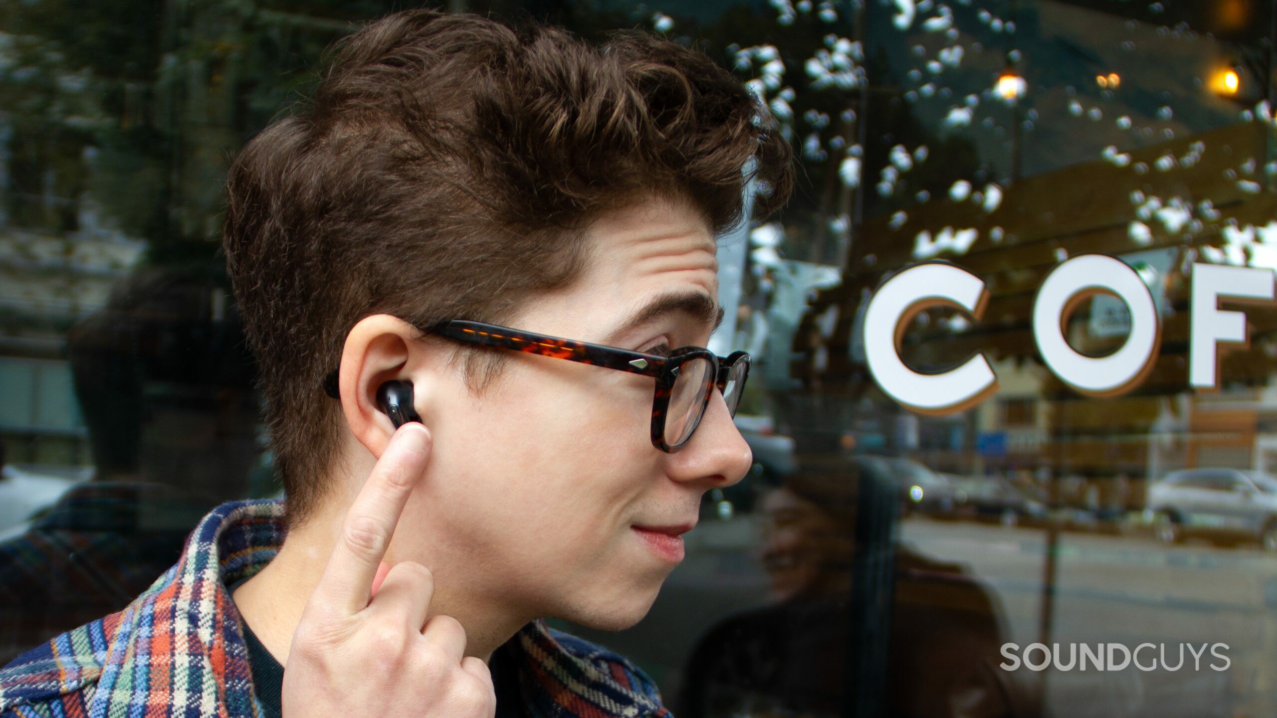 A close up profile of a man using touch controls on the LG TONE Free FP8.