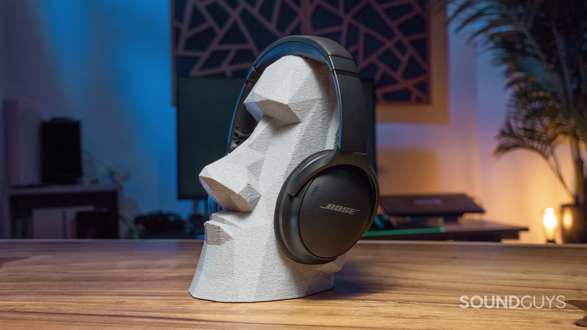 The Bose QuietComfort 45 headphones on a statue head.