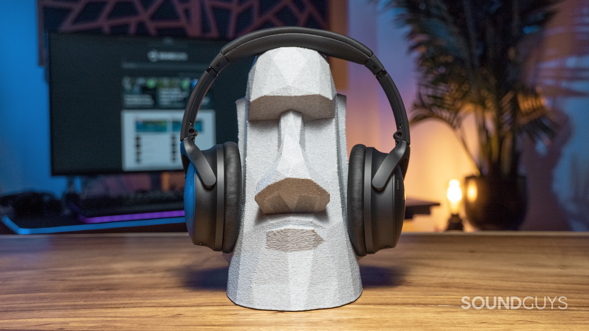 Front view of the Bose QuietComfort 45 worn by a miniature replica of an Easter Island head.