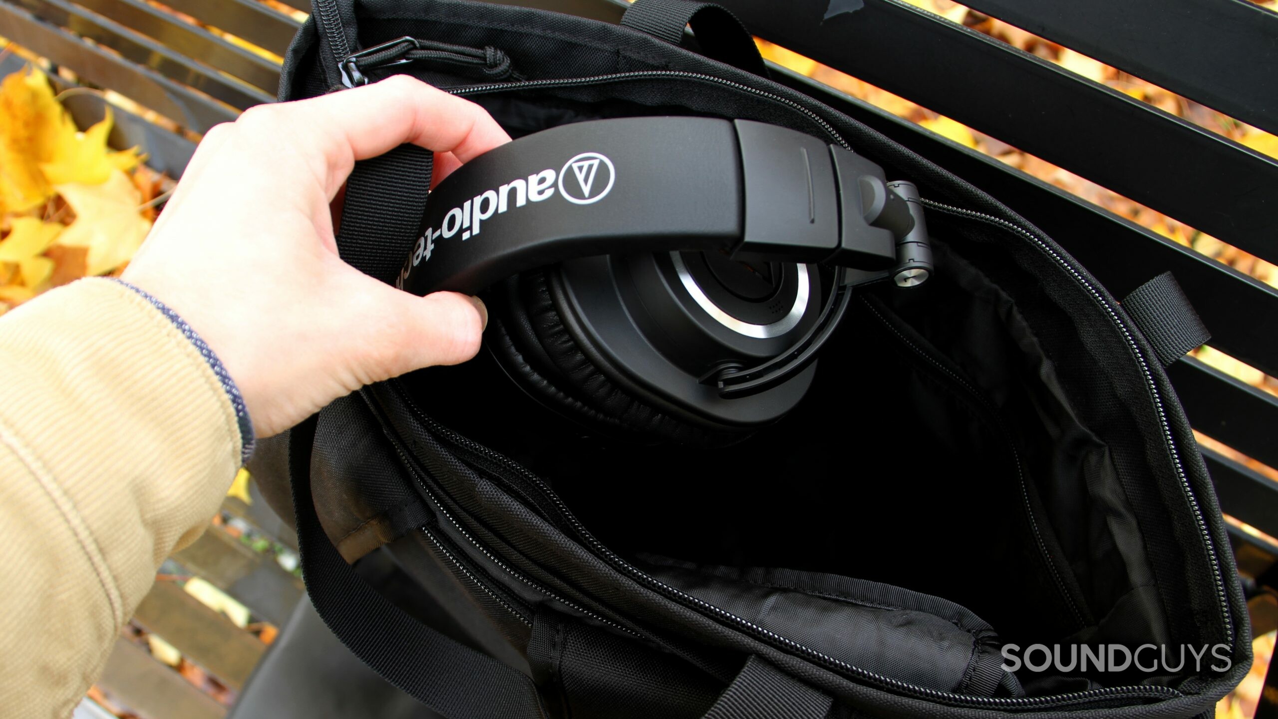 Audio-Technica ATH-M50xBT2 getting stowed away in a black bag.