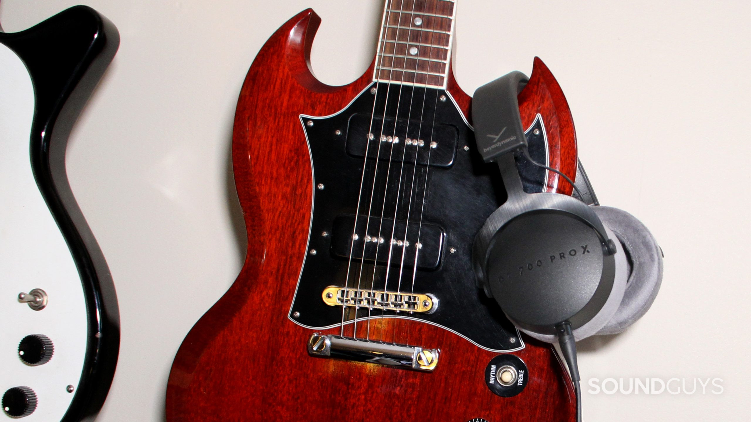 Beyerdynamic DT 700 Pro X slung over the horn of an electric guitar.