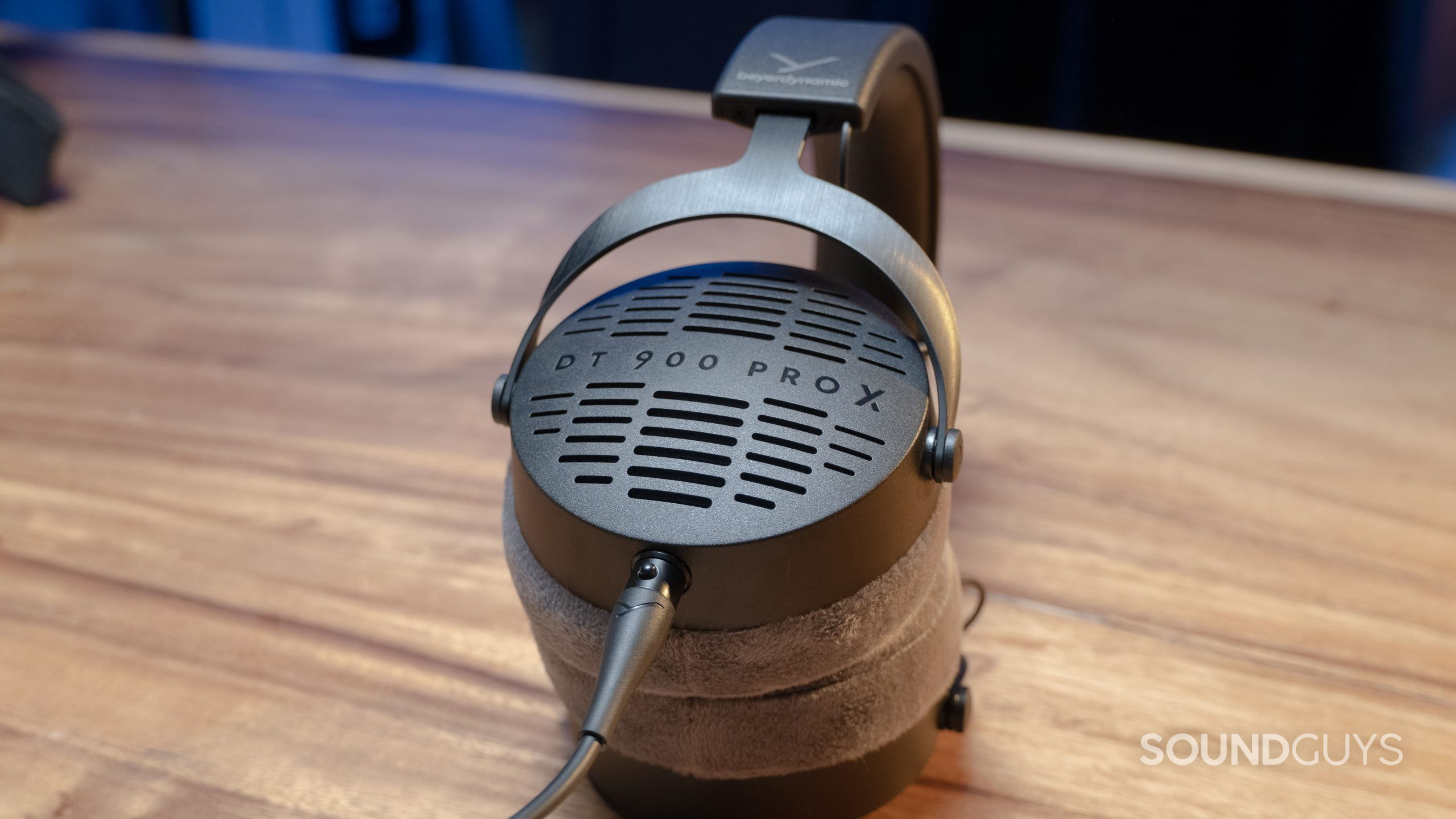 The Beyerdynamic DT 900 Pro X sits on a wood grain table.