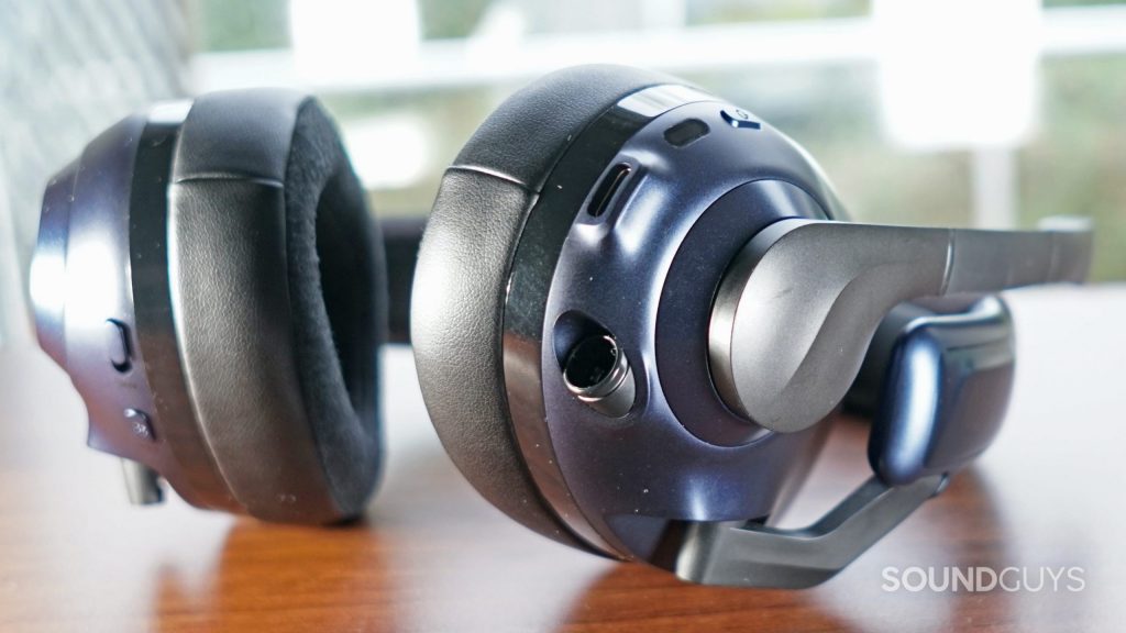 A close up of the EPOS H3PRO Hybrid gaming headset's left headphone, which shows the power button, microphone, USB-C port, and 2.5mm connection port.