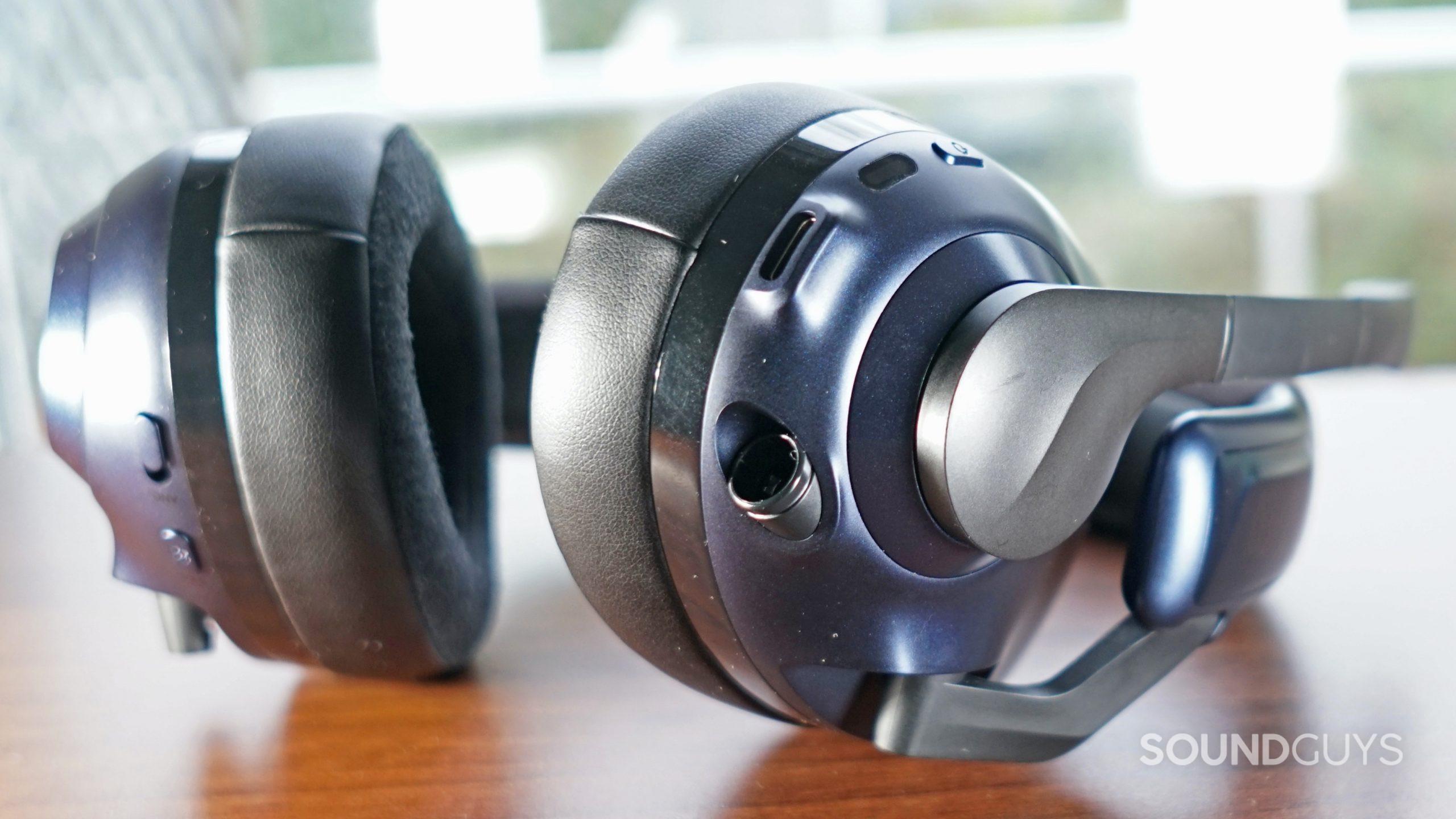A close up of the EPOS H3PRO Hybrid gaming headset's left headphone, which shows the power button, microphone, USB-C port, and 2.5mm connection port.