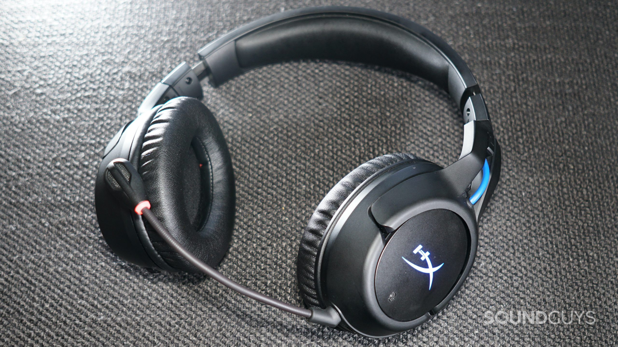 The HyperX Cloud Flight Wireless lays on a fabric surface.