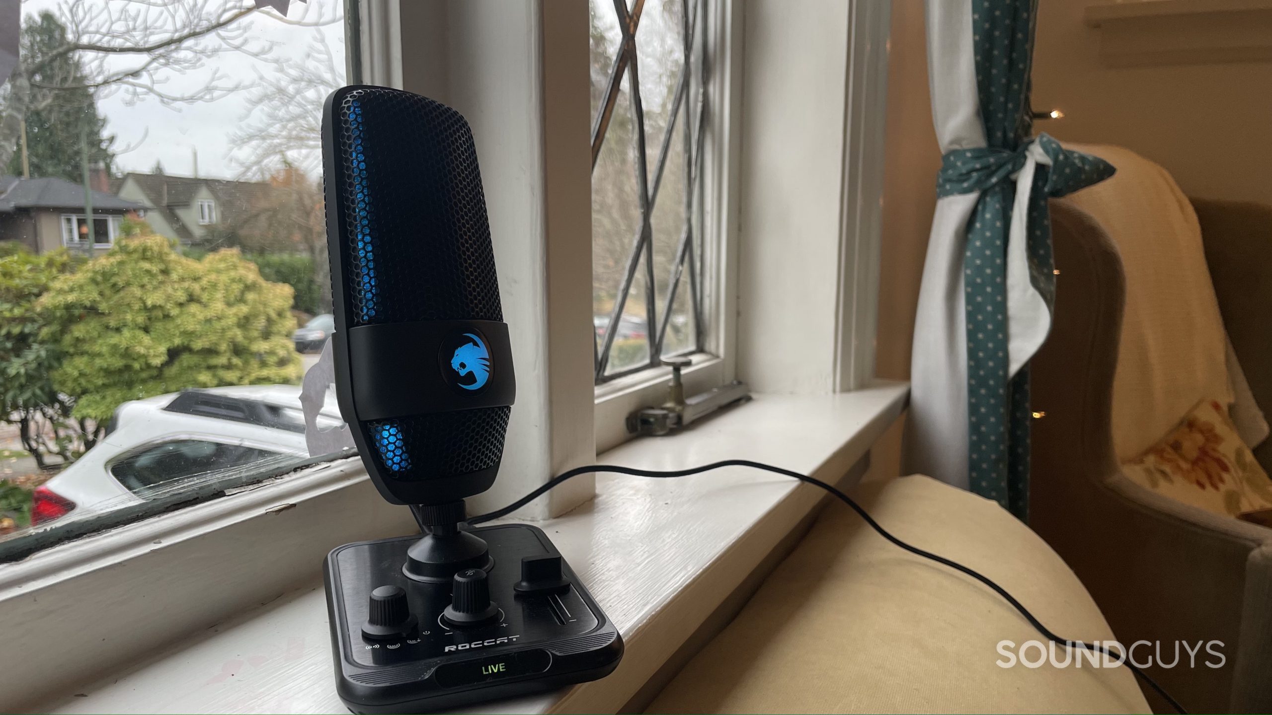 Roccat Torch with blue LED lights on a windowsill.