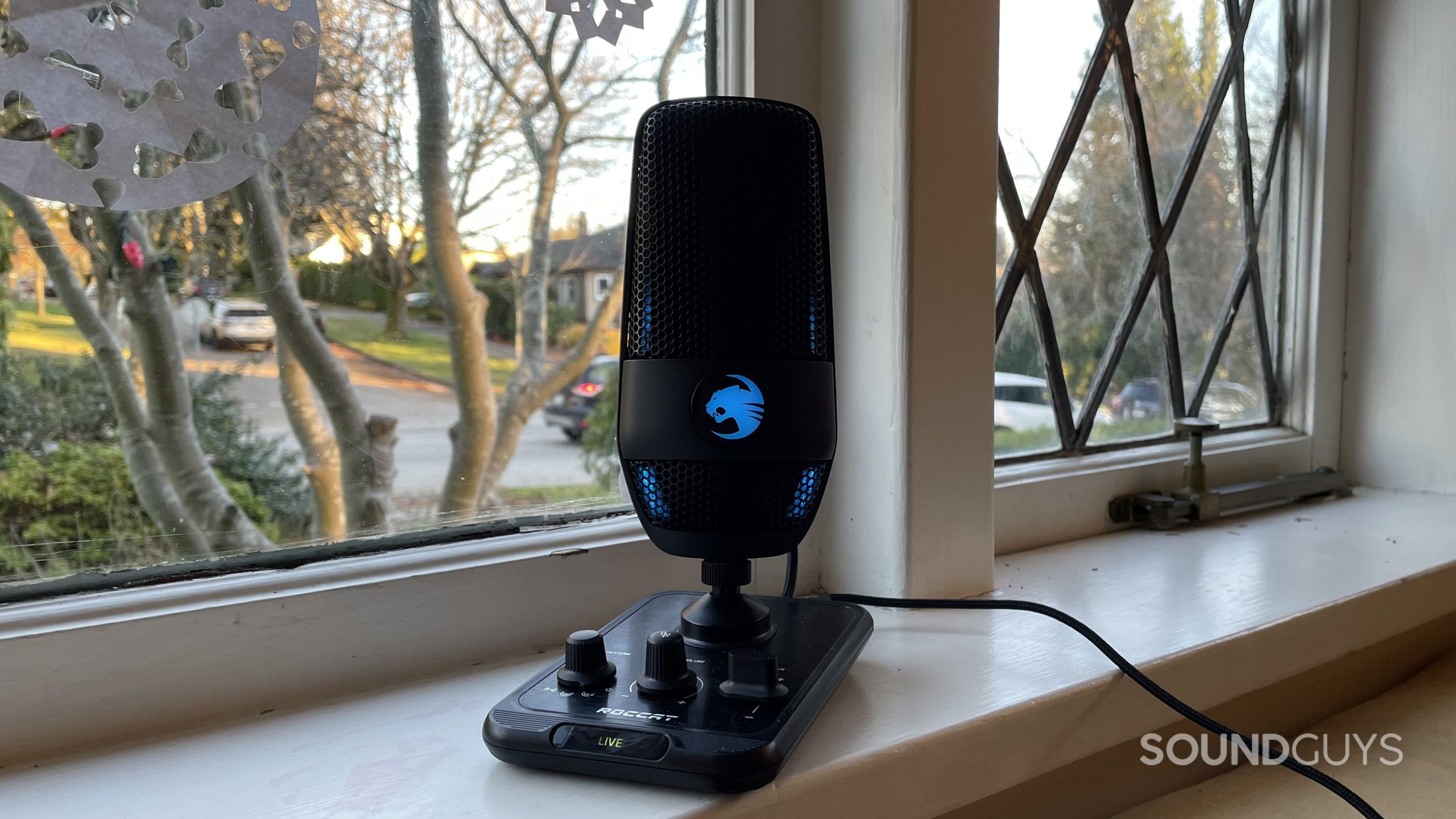 ROCCAT Torch on a windowsill with RGB lights glowing blue.