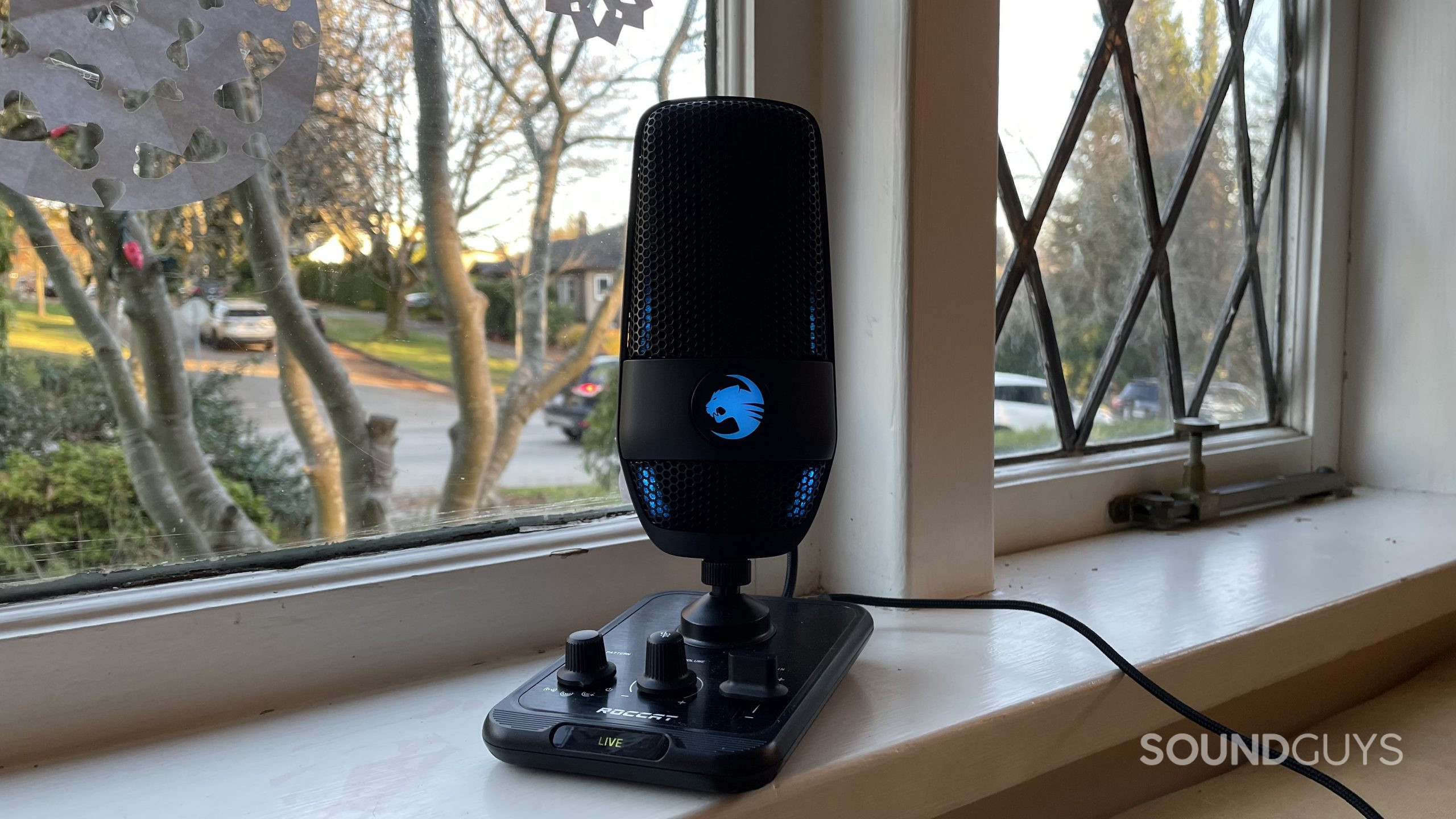 Roccat Torch full blue LED ROCCAT Torch on a windowsill with RGB lights glowing blue.