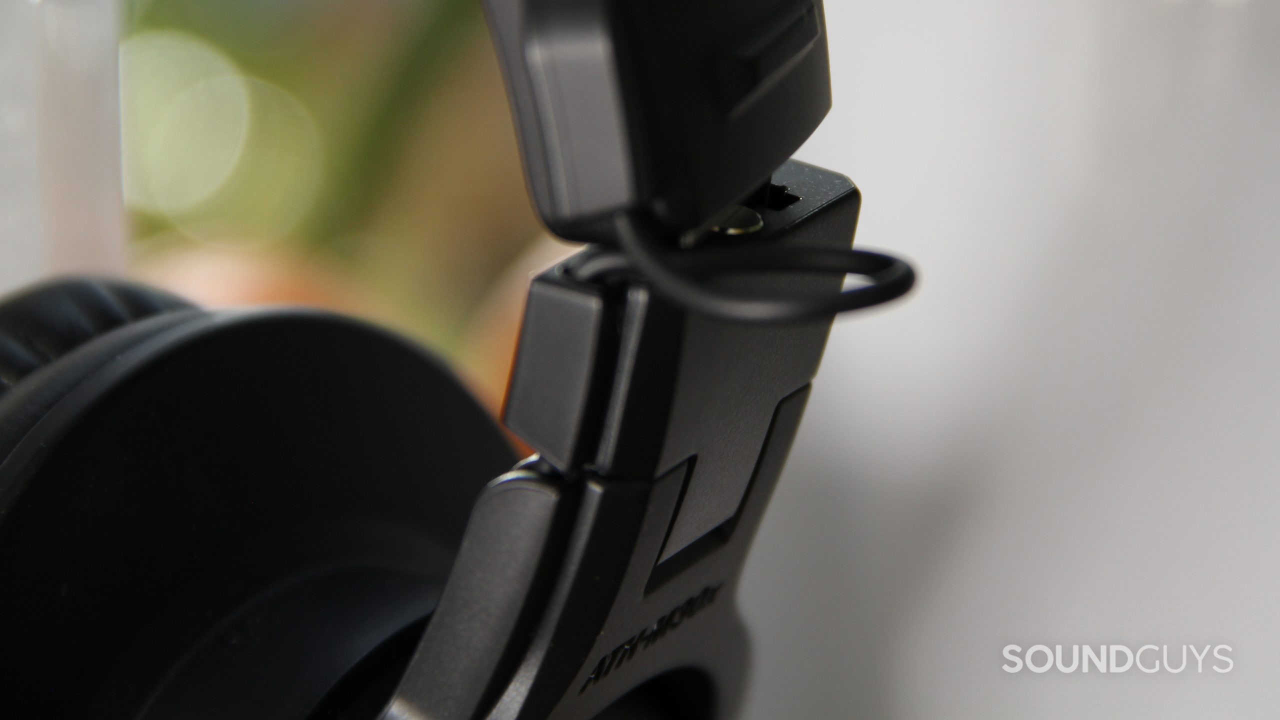 A close up of the plastic and metal Audio-Technica ATH-M30x showing the external wire.