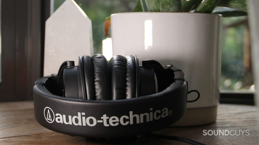 The Audio-Technica ATH-M30x folded up sitting on a wood platform.