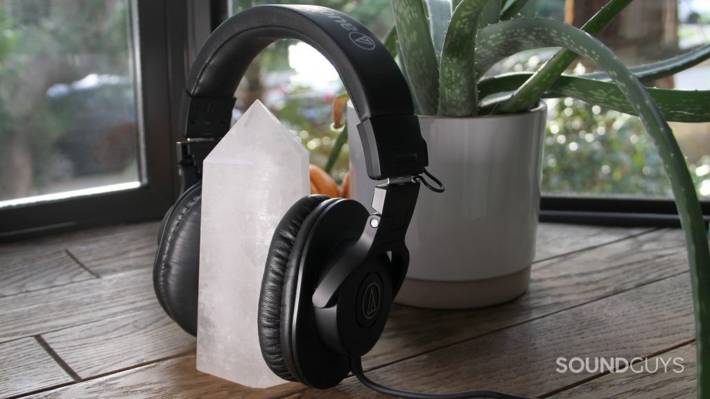 The Audio-Technica ATH-M30x set around a large crystal with a plant in the background.