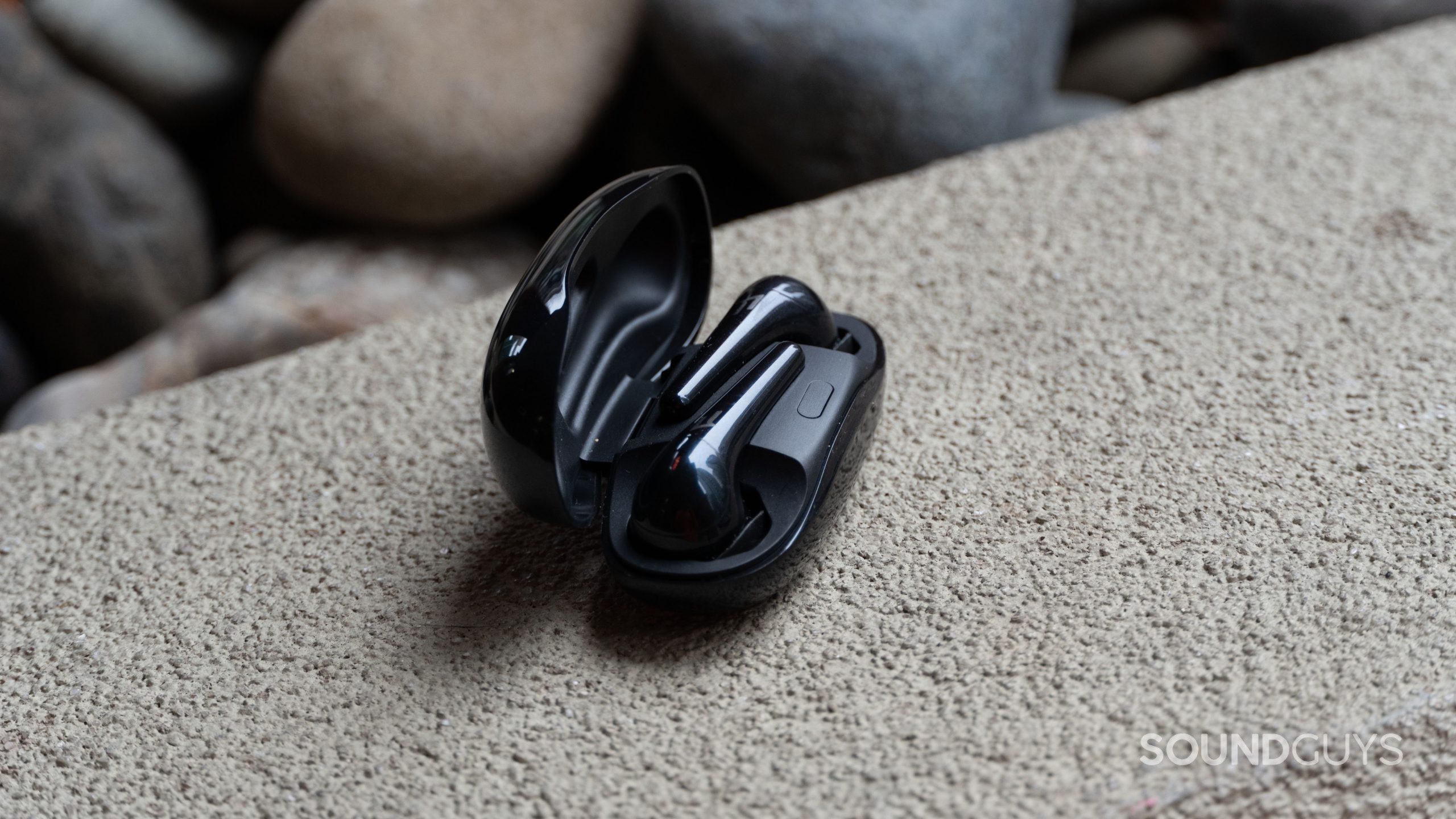 The 1MORE Comfobuds 2 earbuds in the open charging case.