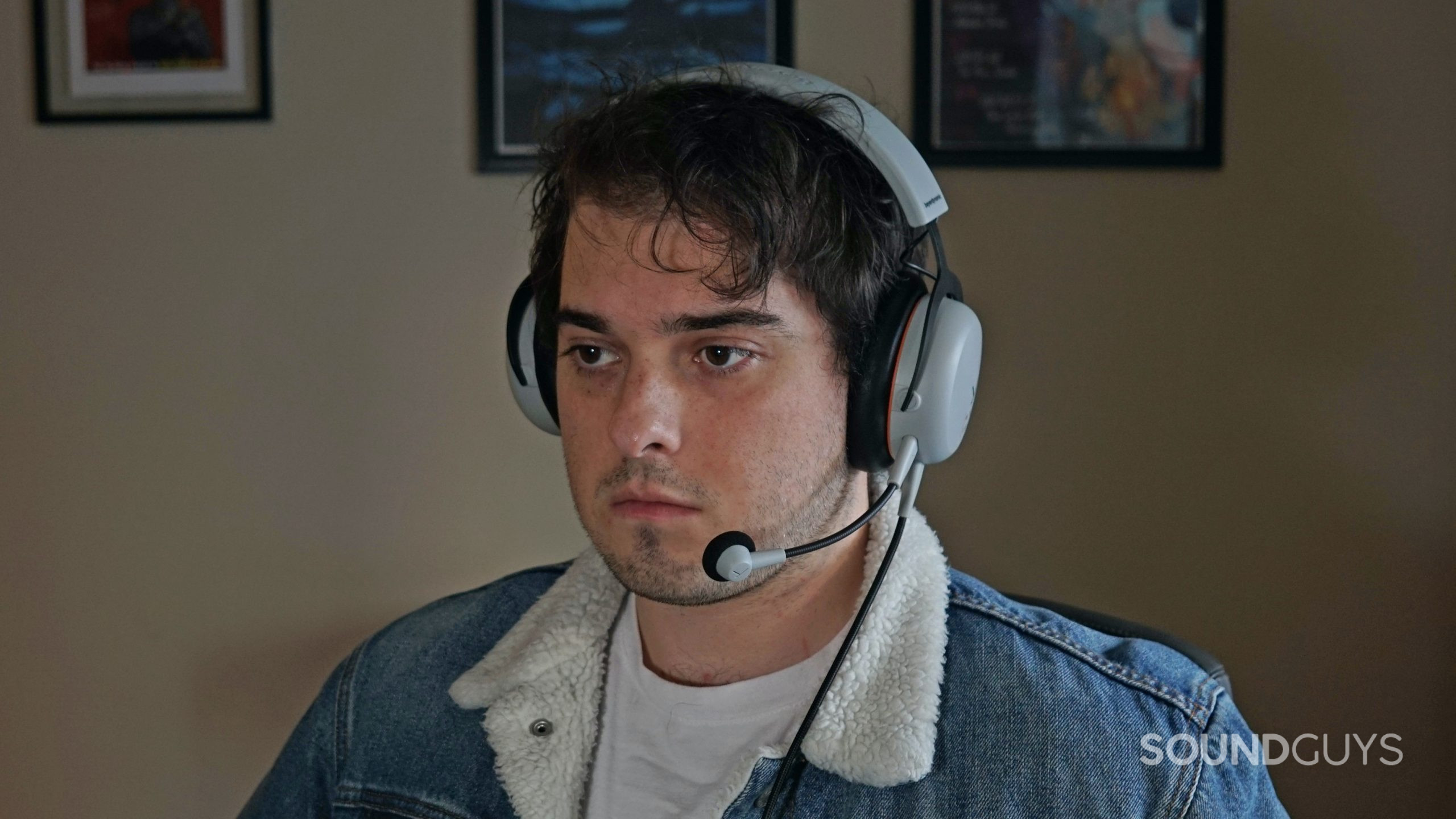 A man sits a computer wearing the Beyerdynamic MMX150 gaming headset.