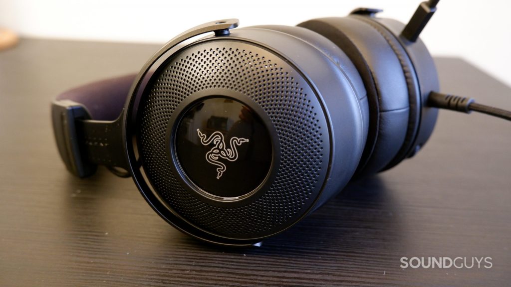 Razer Kraken V3 headset resting on a black table, showing the logo on the ear cup.