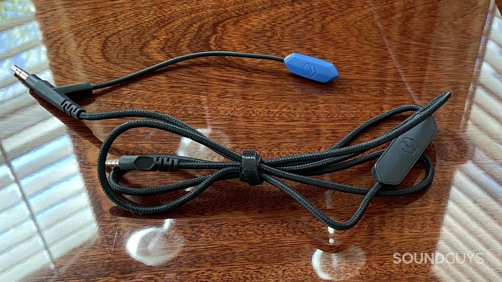V-MODA BoomPro X with its wire wrapped up resting on a reflective wood surface.