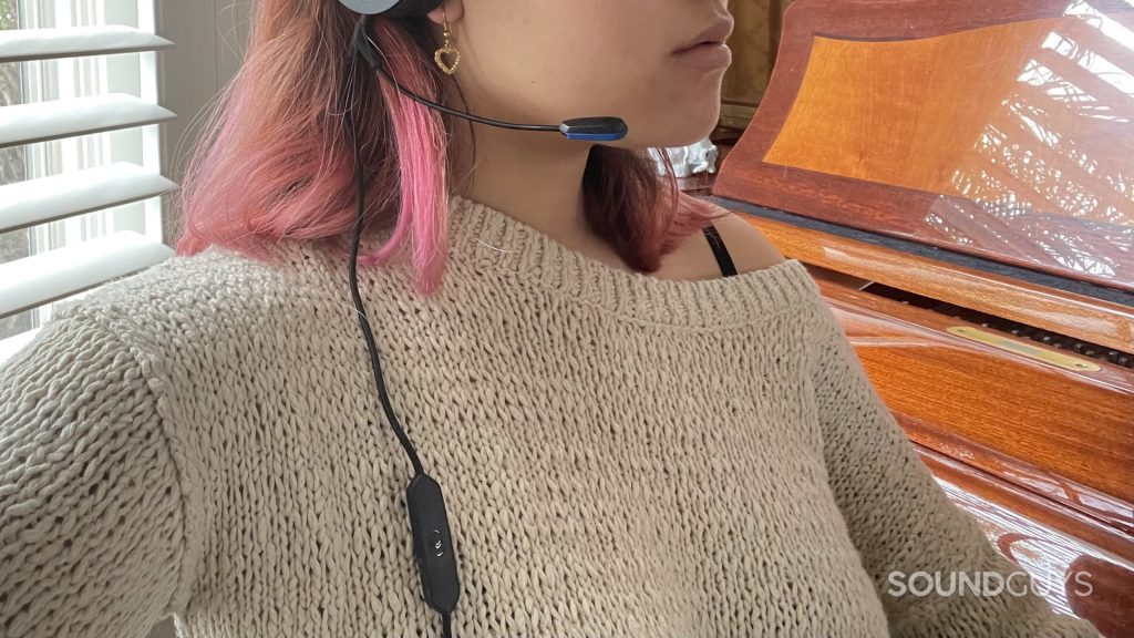 Woman wearing the V-MODA BoomPro X plugged into a pair of headphones.