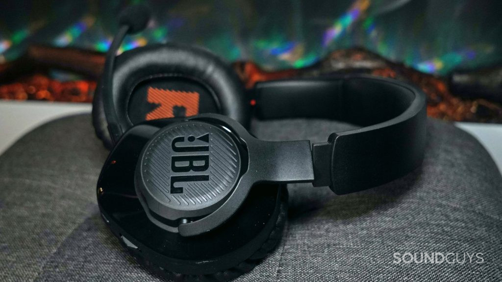JBL Quantum 350 Wireless headphones sits on a stool by a fireplace.