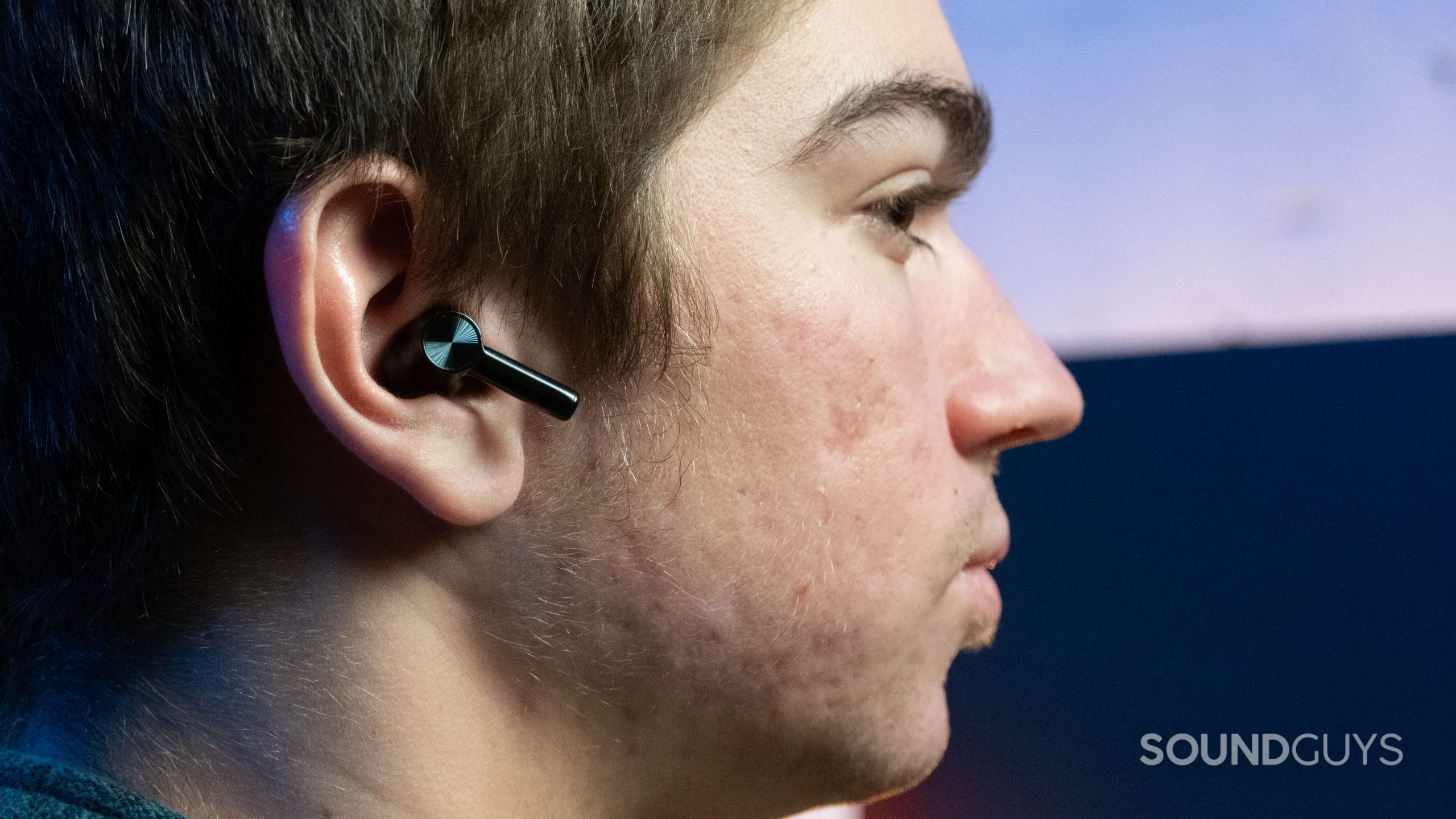 OnePlus Buds Z2 in ear of person sitting at desk