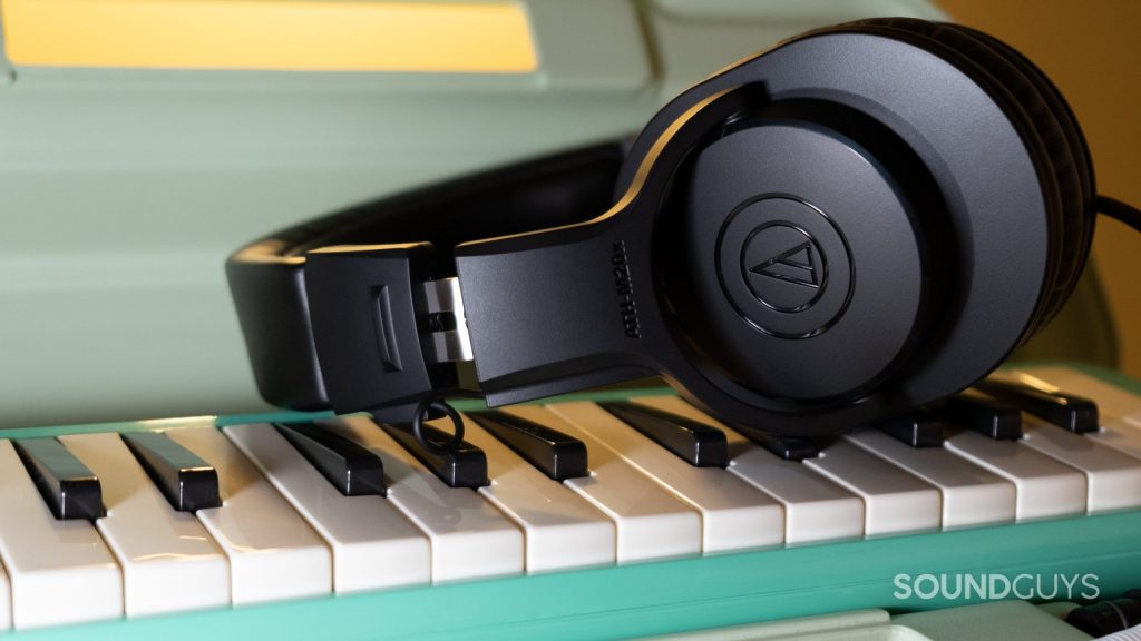 On a melodion the Audio-Technica ATH-M20x rests on its side.