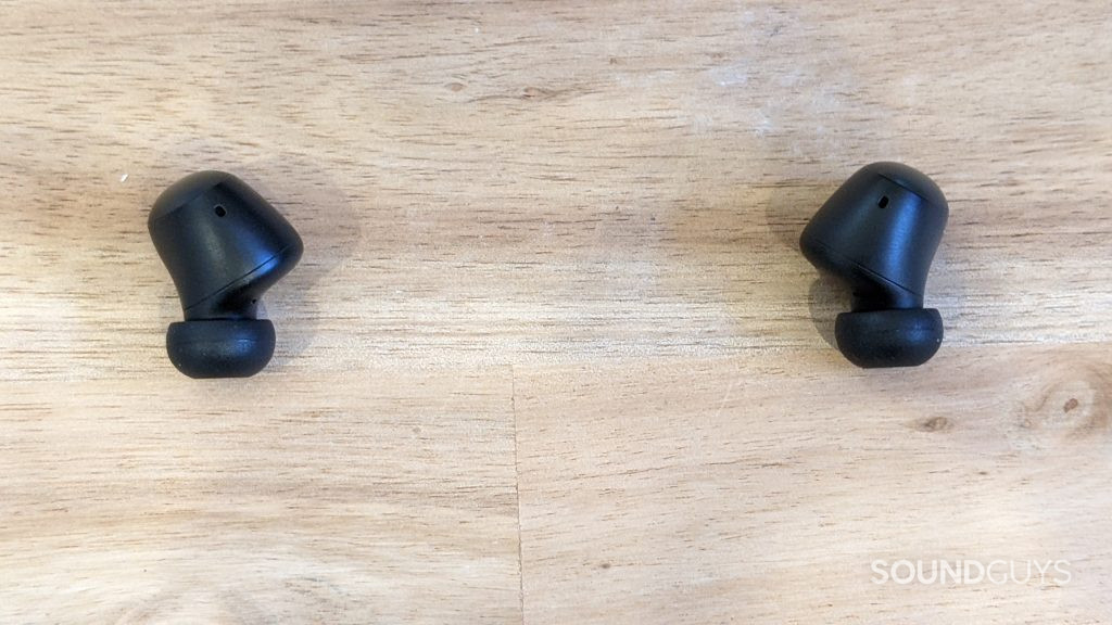 The 1MORE ColorBuds 2 earbuds lying on table out of their case.