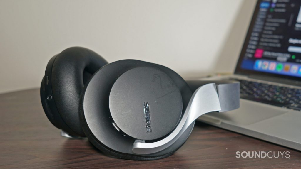 The Shure AONIC 40 lays on an Apple MacBook Pro.
