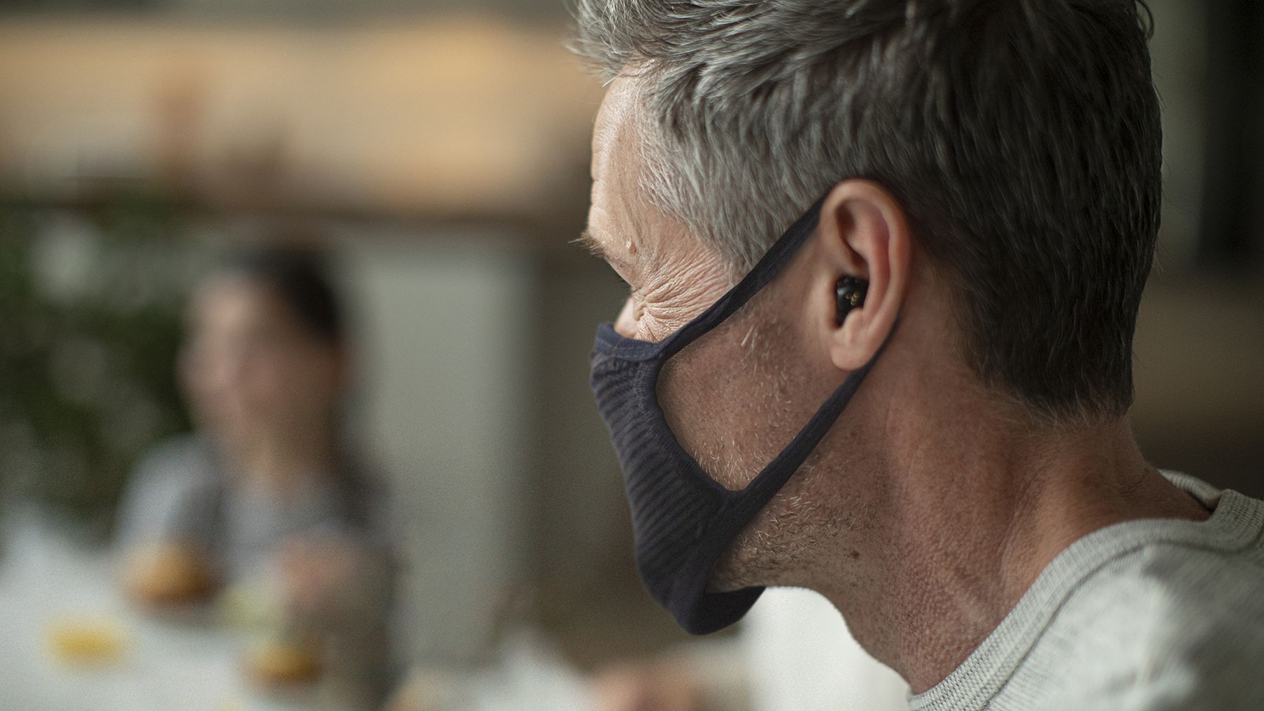 Starkey Livio Edge AI hearing aids worn by a man with a mask.