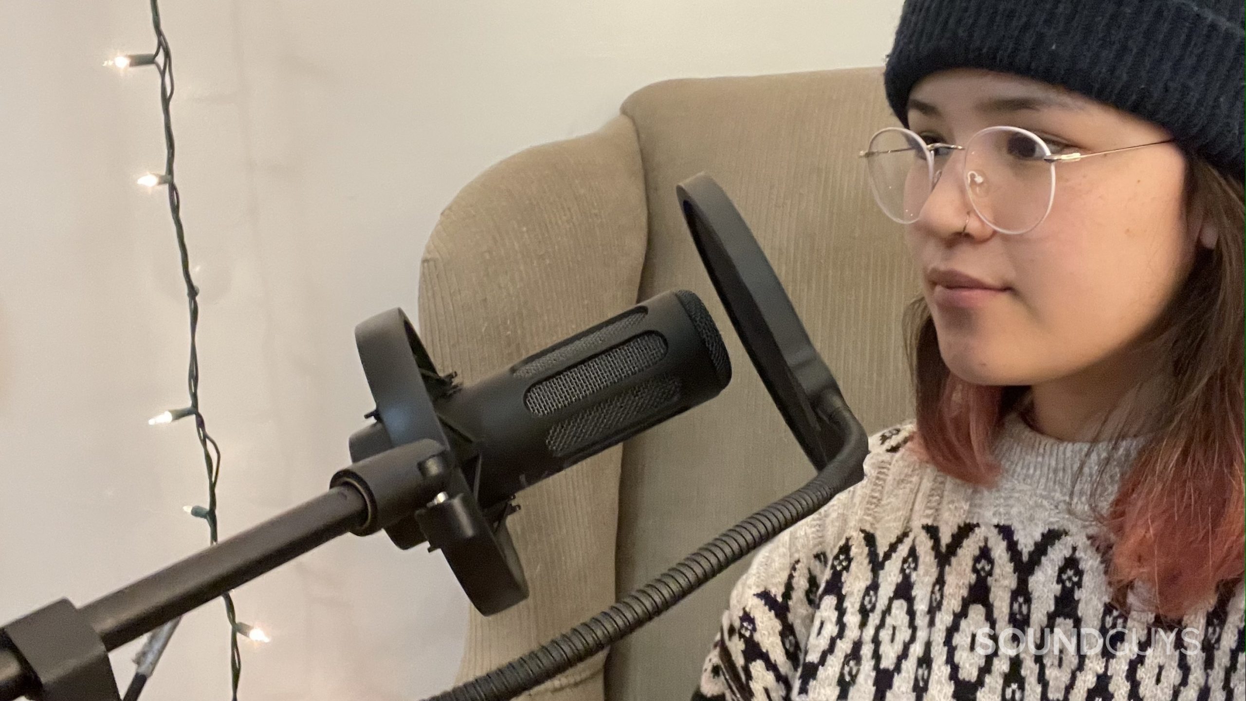 Woman using the beyerdynamic M70 Pro X and pop filter.